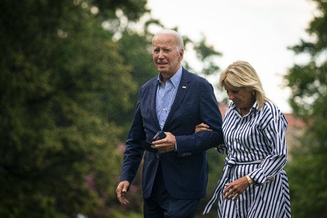 United States President Joe Biden and First Lady Jill Biden walk on the South Lawn of the White House after arriving on Marine One in Washington, D.C., US, on Monday, Aug. 8, 2022. Biden resumed official travel today for the first time since his bout with Covid-19, traveling to Kentucky to show federal support for the state\