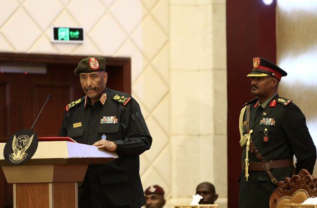 (221206) -- KHARTOUM, Dec. 6, 2022 (Xinhua) -- Abdel Fattah Al-Burhan (L), commander of the Sudanese Army, speaks at the signing ceremony of a political framework agreement in Khartoum, Sudan, Dec. 5, 2022. Sudan\