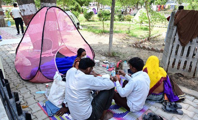 Family members of Covid19 Patient rest at a park outside Swaroop Rani Neharu Hospital in Prayagraj. (Photo by Prabhat Kumar Verma\/Pacific Press\/Sipa USA