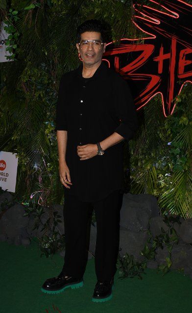 Indian fashion designer Manish Malhotra poses for a photo at the red carpet premiere of the film \