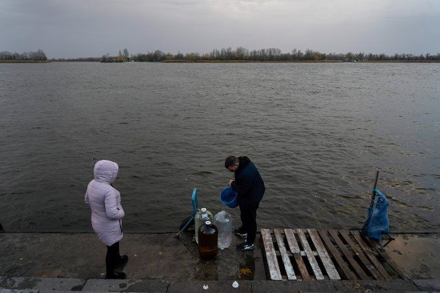 Residents of Kherson seen collecting water at the pier in the Dnipro River as Kherson, the southern regional capital is lacking a basic supply of water, and electricity. Despite Russian troops fled and abandoned the strategic location, Kherson airport was left with wreckage as a result of Ukrainian troops attacked the once Russian based during the occupation. The airport was once a civil and military airport. (Photo by Ashley Chan \/ SOPA Images\/Sipa USA