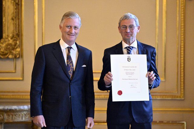 King Philippe - Filip of Belgium and Jean Janssens of Difrosett Printing pictured during a royal reception with the newly appointed suppliers holding a \