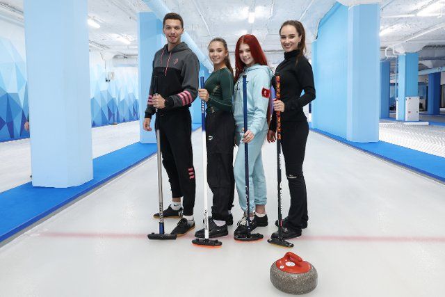 MOSCOW, RUSSIA  JULY 27, 2022: Ice dancer Dmitry Solovyov, figure skaters Kamila Valiyeva, Aleksandra Trusova, and curler Anna Sidorova (L-R) pose for a photo during a curling masterclass at the Moscow curling club. Valery Sharifulin\/TASS\/Sipa