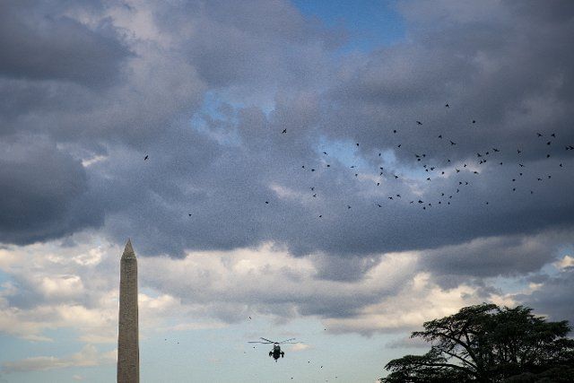 Marine One, with US President Joe Biden aboard, flies past the Washington Monument prior to landing on the South Lawn of the White House in Washington, D.C., US, on Monday, Aug. 8, 2022. Biden resumed official travel today for the first time since his bout with Covid-19, traveling to Kentucky to show federal support for the state\