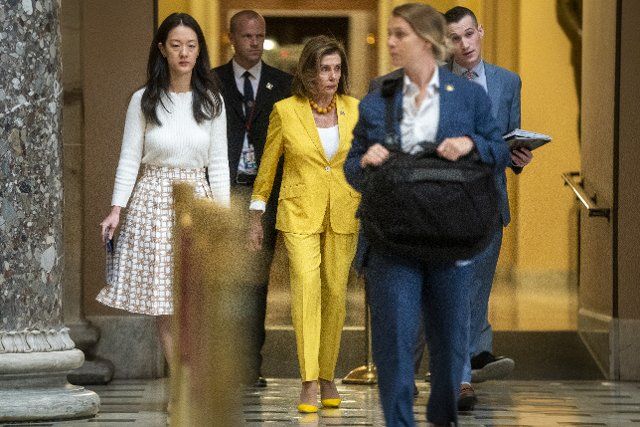 Speaker of the House Nancy Pelosi talks with staff members as she walks through Statuary Hall of the US Capitol in Washington, DC, USA, 12 August 2022. House Democrats continue their work to pass the Inflation Reduction Act, a major spending bill that includes provisions for climate change, health care and corporate tax increases