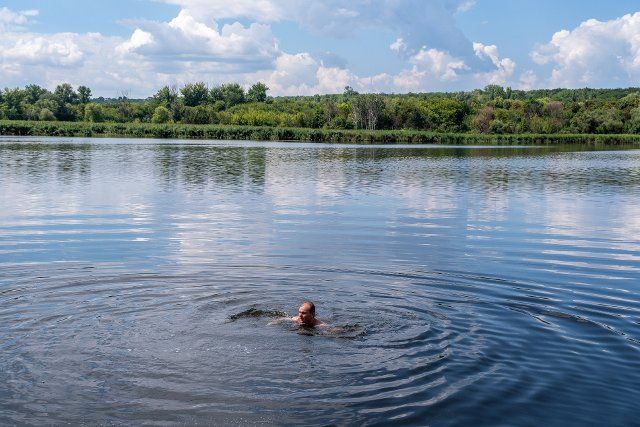 A man seen swimming in a lake close to the frontline in Slovyansk. Slovyansk had a population of 106,972 (2021 est.), now stands as a main strategic city in the Donetsk region of Donbas, as the city was continuously been heavily bombarded by Russian artilleries and missiles, since the war started, over 80% of the civilian have already evacuated from the war. (Photo by Alex Chan Tsz Yuk \/ SOPA Images\/Sipa USA