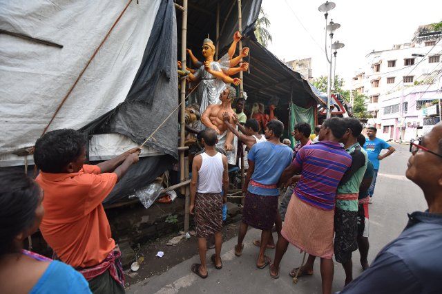 Clay made Durga idol is being transported from a sculptor\