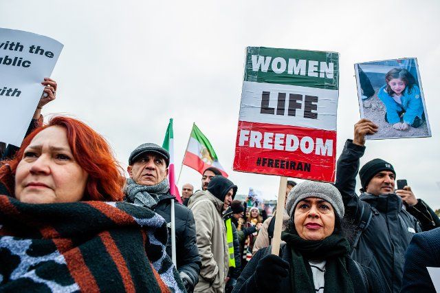 A Iranian woman seen holding a placard with slogan Woman, Life, Freedom during the demonstration. Iranian people gathered at the Malieveld in The Hague to commemorate the 2019 Bloody November protests over fuel prices  protests which were ultimately put down by government force and where over 1,500 protesters were killed by security forces. Iraanse rapper & influencer Hichkas performed during this protest in solidarity with the revolt against the Islamic Republic regime. (Photo by Ana Fernandez \/ SOPA Images\/Sipa USA