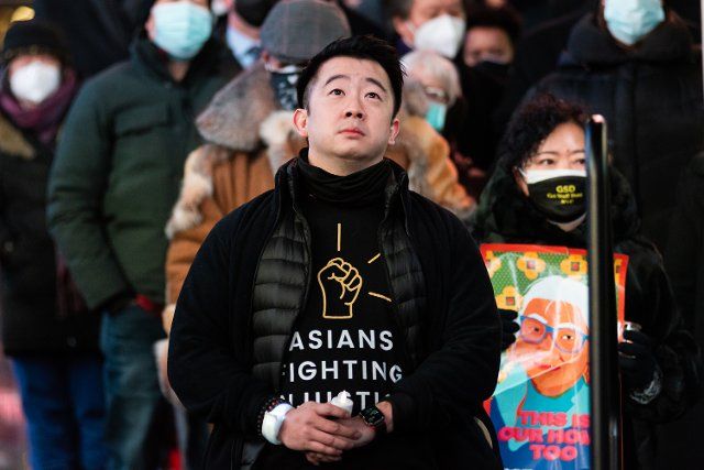 Asian Fighting Injustice founder Ben Wei (middle) attends a candlelight vigil for Michelle Alyssa Go in Times Square in New York, NY, on Jan. 18, 2022. 40-year-old Michelle Go was killed on Jan. 15 when an emotionally disturbed homeless man pushed her in front of an MTA subway train inside the Times Square 42nd Street subway station. (Photo by Gabriele Holtermann\/Sipa USA