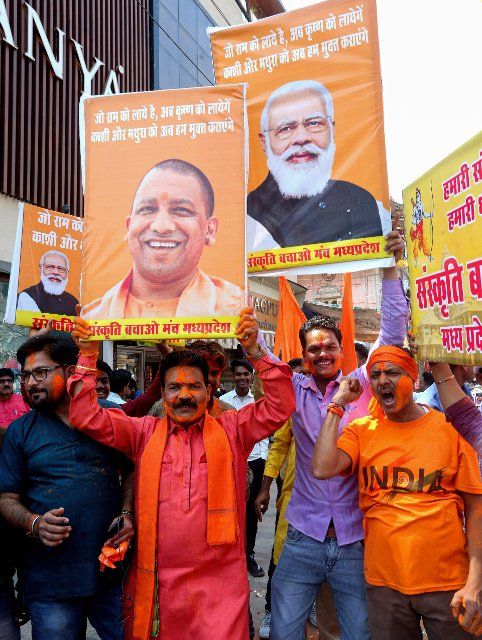 Bharatiya Janata Party and Sanskriti Bachao Manch activists hold posters of Prime Minister Narendra Modi and Chief Minister of Uttar Pradesh Yogi Adityanath as they celebrate the lead of BJP in Uttar Pradesh, Manipur, Goa and Uttarakhand State Assembly elections. Votes are counted in five States after the Assembly elections, out of which BJP is leading in four States except in Punjab. (Photo by Sanjeev Gupta \/ SOPA Images\/Sipa USA