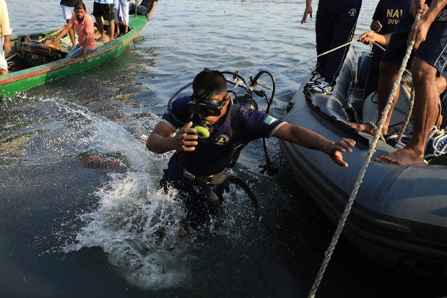 Divers seen in Shitalakshya river in Narayanganj during the rescue operation after a launch capsized. At least six people died and dozens remain missing as a launch capsized after it was hit by a cargo vessel on Sunday afternoon. (Photo by Md Manik \/ SOPA Images\/Sipa USA
