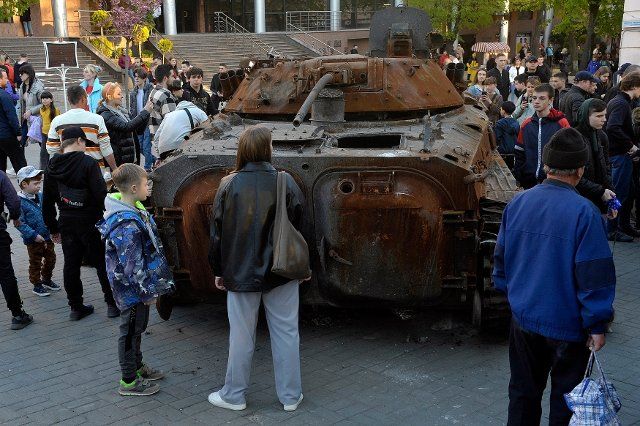 People look at a Russian tank and an APC destroyed in heavy fighting near Bucha and Irpin, Kyiv Region, that are put on display as a show of defiance and a reminder that the war is near in Yevropeiska Square, Vinnytsia, central Ukraine, May 5, 2022. Photo by Oleksandr Lapin\/Ukrinform\/Abaca\/Sipa