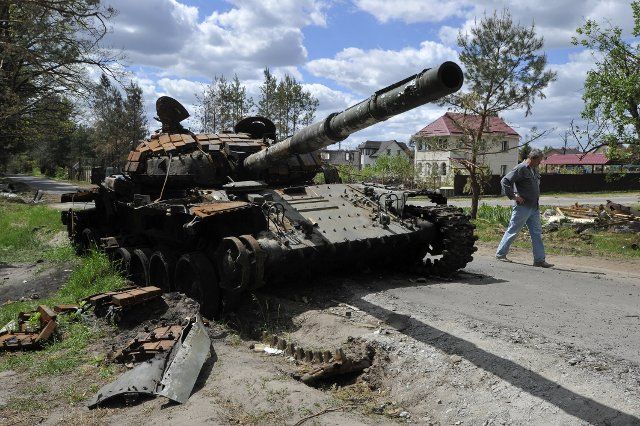 A man walks past a destroyed tank of the Russian army seen in the village of Mykolaivka in Kyiv Region. Russia invaded Ukraine on 24 February 2022, triggering the largest military attack in Europe since World War II. (Photo by Sergei Chuzavkov \/ SOPA Images\/Sipa USA