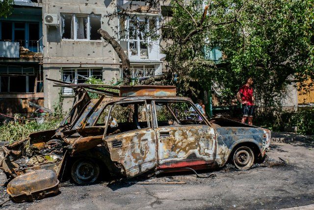 A man stands near a burnt and destroyed car. Sloviansk is a city located at 20 km north from Kramatorsk towards Lyman frontline and it is part of the Donetsk region. In the night between May 30 and May 31 the city was attacked by the Russian army, a missile attack destroyed several buildings in the city centre killing three civilians and injuring six. (Photo by Rick Mave \/ SOPA Images\/Sipa USA