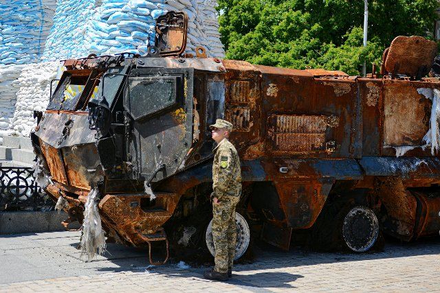 Ukrainian serviceman examines destroyed Russian KAMAZ displayed in the center of Kyiv. An exhibition of burnt Russian tanks and other armored vehicles continues in the Ukrainian capital to draw attention to the war raging in other parts of the country. (Photo by Aleksandr Gusev \/ SOPA Images\/Sipa USA