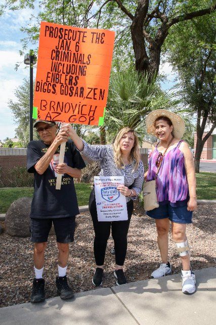 A small group of protesters gather outside the office of Rep. Andy Biggs Congressional Office at Superstition Plaza in Mesa, Arizona USA on June 9, 2022. They gathered to protest his role in the January 6th attempted coup and to call on Secretary of State Katie Hobbs to block Biggs, Paul Gosar, and Mark Finchem from the Arizona Ballot for their roles in an insurrection against the U.S. Government. (Photo by: Alexandra Buxbaum\/Sipa USA