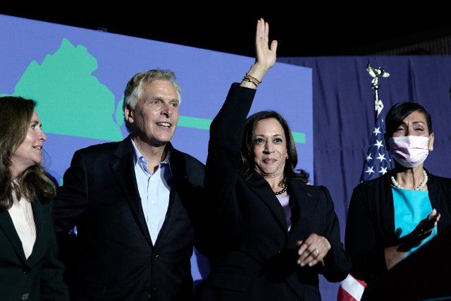 United States Vice President Kamala Harris, right, and Terry McAuliffe, the Democratic Party nominee for Governor of Virginia, left, wave to the crowd at his campaign event in Dumfries, Virginia on Thursday, October 21, 2021. Credit: Yuri Gripas \/ 