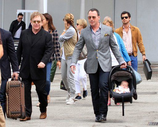 Sir Elton John and David Furnish with their son Zachary are spotted arriving at Marco Polo Airport in Venice.. .Pictured: Elton John, David Furnish and Zachary. . Ref: SPL281128 010611 .Picture by: Maurizio La Pira \/ Splash News . . ...
