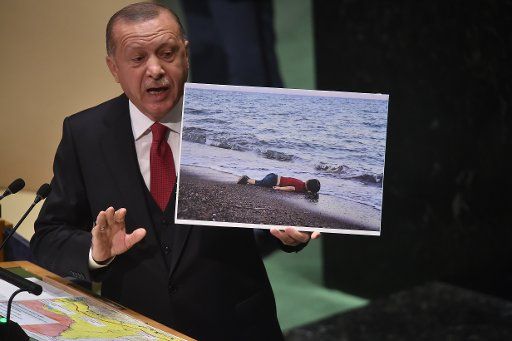 September 24, 2019 - New York, NY USA: Recep Tayyip Erdogan, President, Republic of Turkey holds up photo of toddler who washed up to Turkey\