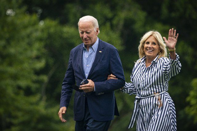 8\/8\/2022 - Washington, District of Columbia, United States of America: United States President Joe Biden and First Lady Jill Biden walk on the South Lawn of the White House after arriving on Marine One in Washington, D.C., US, on Monday, Aug. 8, 2022. Biden resumed official travel today for the first time since his bout with Covid-19, traveling to Kentucky to show federal support for the state\