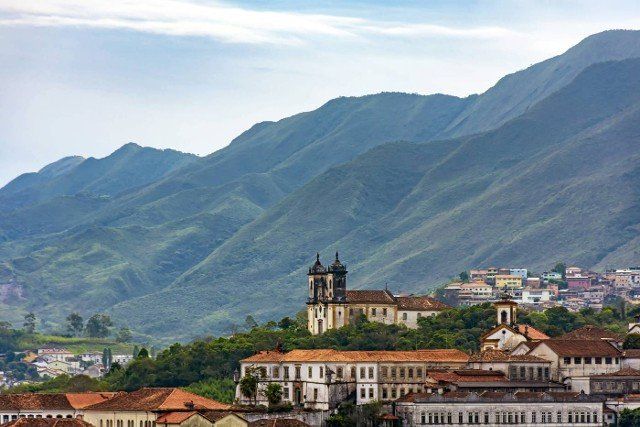 Curches,  houses and mountains of Ouro Preto city in Minas Gerais with its colonial-style houses and churches and the mountains in the background