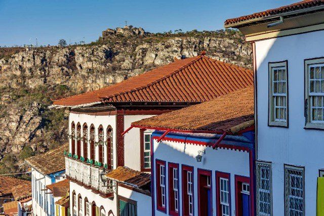 Detail of colonial style streets and houses in the old and historic city of Diamantina in Minas Gerais with the mountains in the background during the late afternoon