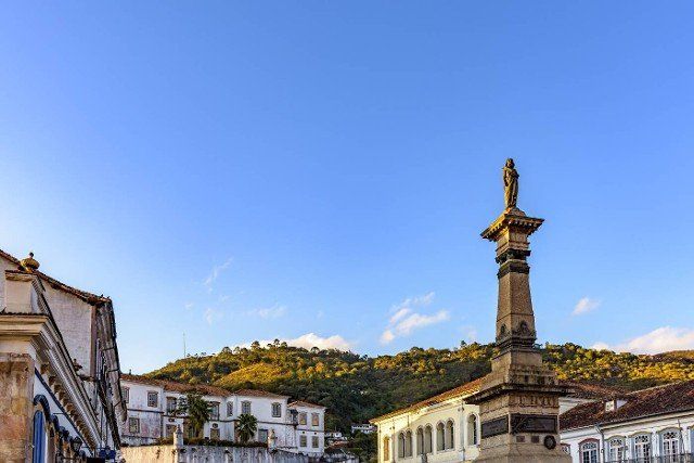 Central square of the historic town of Ouro Preto surrounded by colonial-style houses and hills