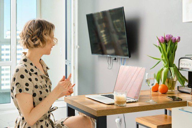 Woman making video call to business partner using laptop,  looking at screen with virtual web chat
