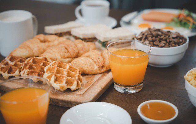 Breakfast served food with beverage coffee,  orange juice on table in the morning at home,  Fresh and bright continental breakfast healthy