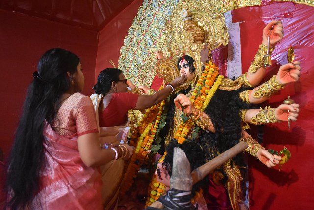 A woman offers sweets to an idol of the Hindu goddess Durga while offering prayers on the last day of the Durga Puja festival in Kolkata. (Photo by Sudipta Das \/ Pacific Press
