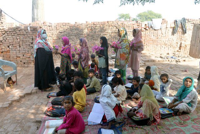 Pakistani teachers of United Social Welfare Society teaching their class (Dissable Students Class) a government funded Non Formal Basic Education School (NFBES) on the eve of World Teachers’ Day at a bricks kiln in the outskirts of Lahore. During the celebration of World Teachers’ Day held annually on October 5 since 1994 which commemorates teachers organizations worldwide. Its aim is to mobilize support for teachers and to ensure that the needs of future generations will continue to be met by teachers. (Photo by Rana Sajid Hussain\/Pacific Press