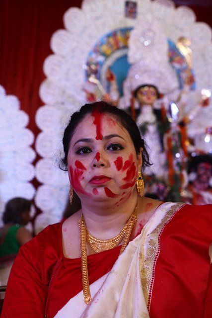 A woman face covered with vermilion, in a puja Pandal, in New Delhi on 5th October 2022. Women play holi with vermilion on the last day of Durga Puja festival, in India. Before Godess Durga idol immersion (Photo by Ranjan Basu\/Pacific Press