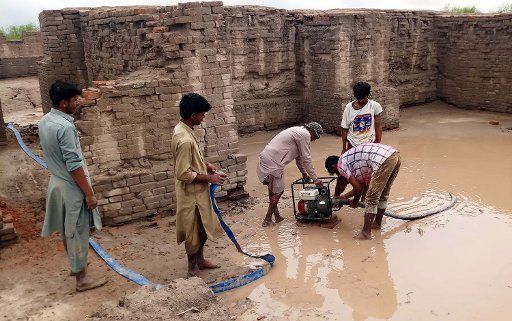 MOHENJO DARO, PAKISTAN, AUG 26: Laborers are draining out accumulated rain water caused damage to the World Heritage monuments in Mohenjo Daro on Wednesday, August 26, 2020. (Jamal Dawoodpoto\/PPI Images