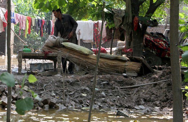 CHARSADDA, PAKISTAN, SEP 06: Rain-affected people search useable house-hold items near debris of their house, which was damaged by heavy territorial rains and flood, at Garhi Momin area in Charsadda on Tuesday, September 06, 2022. (Fahad Pervez\/PPI Images
