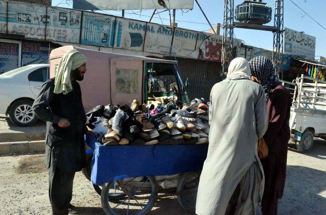 QUETTA, PAKISTAN, DEC 06: Shoes are being selling at a roadside stall as the demand of warm clothes and shoes increased in city on the arrival of cold waves of winter season, at Sariyab road in Quetta on Tuesday, December 06, 2022. (Sami Khan\/PPI Images