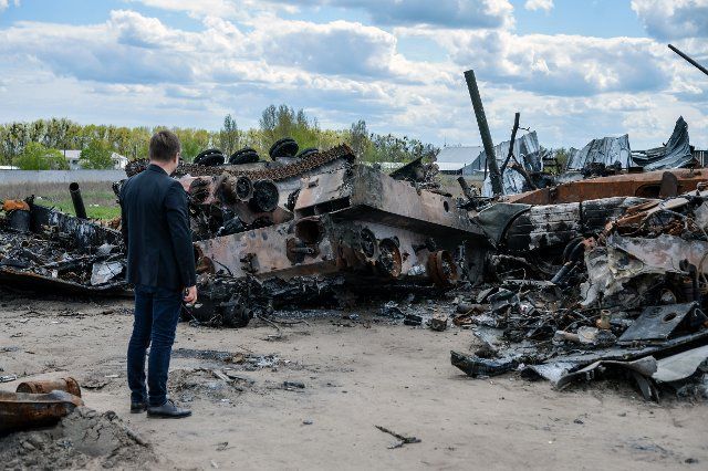BUCHA, UKRAINE - MAY 4, 2022 - A man looks at destroyed Russian military vehicles at an automobile graveyard, Bucha, Kyiv Region, northern Ukraine. This photo cannot be distributed in the Russian Federation., Credit:Evgen Kotenko \/ Avalon