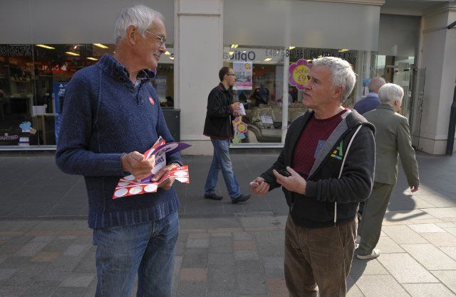 SCOTLAND Perth -- 12 Sep 2014 -- Dave Prentice, 70, a No volunteer campaigner debates with a Yes supporter as he hands out No stickers in the High Street in Perth, Scotland, UK. Campaigning by both camps continues on the last weekend of the 
