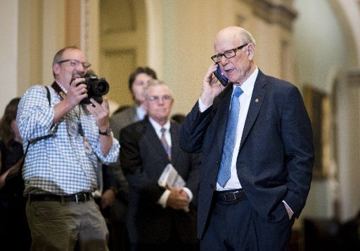UNITED STATES - JULY 18: Sen. Pat Roberts, R-Kan., pretends to speak with President Donald Trump in the Ohio Clock Corridor as he leaves the Senate Republicans\
