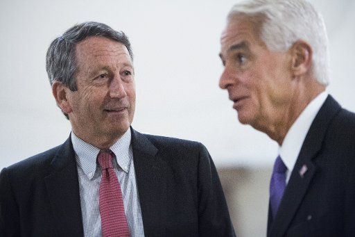 UNITED STATES - DECEMBER 13: Reps. Mark Sanford, R-S.C., left, and Charlie Crist, D-Fla., leave a briefing in the Capitol Visitor Center with members of the House on the U.S. relationship with Saudi Arabia in regard to the murder of journalist Jamal Khashoggi and Yemen on December 13, 2018. Secretary of State Mike Pompeo and Defense Secretary James Mattis, conducted the briefing. (Photo By Tom Williams\/CQ Roll Call)