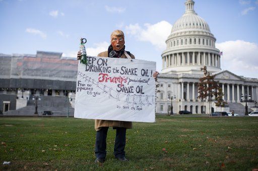 UNITED STATES - NOVEMBER 08: A man with a Donald Trump mask is seen near a weekly rally with Jane Fonda, to call for action on the Green New Deal on the East Front of the Capitol on Friday, November 8, 2019. (Photo By Tom Williams\/CQ Roll Call)