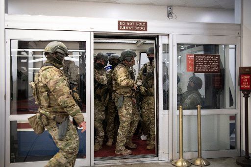UNITED STATES - January 6: U.S. National Guard officers take the Senate subway as the Capitol is under lockdown in Washington on Wednesday, Jan. 6, 2021. (Photo by Caroline Brehman\/CQ Roll Call