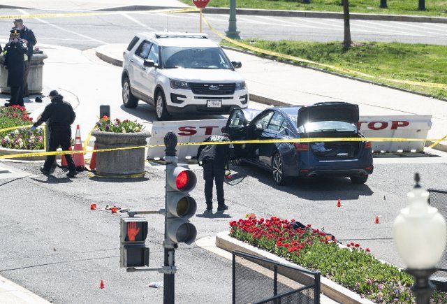 UNITED STATES - APRIL 2: Capitol Police investigate the scene after a vehicle drove into a security barrier near the U.S. Capitol building on Friday April 2, 2021. Two officers were reported injured with the driver of the vehicle fatally shot. (Photo By Bill Clark\/CQ Roll Call