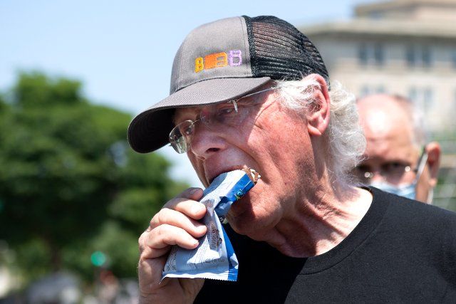 UNITED STATES - May 20: Ben Cohen, Co-founder of Ben & Jerryâs, eats an ice cream bar at an event on police reform and ending qualified immunity outside of the U.S. Supreme Court in Washington on Thursday, May 20, 2021. (Photo by Caroline Brehman\/CQ Roll Call