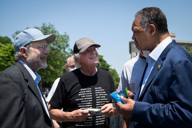 UNITED STATES - May 20: Ben Cohen, left, Jerry Greenfield, Founders of Ben & Jerryâs, talk with civil rights activist Jesse Jackson at an event on police reform and ending qualified immunity outside of the U.S. Supreme Court in Washington on Thursday, May 20, 2021. (Photo by Caroline Brehman\/CQ Roll Call