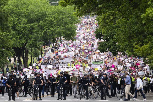 UNITED STATES - MAY 14: Demonstrators are seen on Constitution Avenue during a march for abortion rights in response to the Supreme Courtâs leaked draft opinion indicating the Court will overturn Roe v. Wade, on Saturday, May 14, 2022. (Tom Williams\/CQ Roll Call