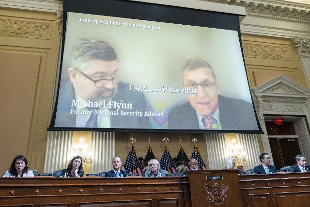 UNITED STATES - JUNE 28: Michael Flynn, former National Security Advisor to former President Donald Trump, is seen on a monitor as Cassidy Hutchinson, an aide to former White House Chief of Staff Mark Meadows, testified during the Select Committee to Investigate the January 6th Attack on the United States Capitol hearing to present previously unseen material and hear witness testimony in Cannon Building, on Tuesday, June 28, 2022. Appearing from left, Reps. Stephanie Murphy, D-Fla., Elaine Luria, D-Va., Adam Schiff, D-Calif., Zoe Lofgren, D-Calif., Chairman Bennie Thompson, D-Miss., vice chair Rep. Liz Cheney, R-Wyo., staff counsel, and Adam Kinzinger, R-Ill. (Tom Williams\/CQ Roll Call