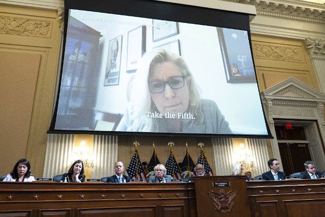 UNITED STATES - JUNE 28: Vice chair Rep. Liz Cheney, R-Wyo., is seen on a monitor questioning Michael Flynn, former National Security Advisor to Donald Trump, as Cassidy Hutchinson, an aide to former White House Chief of Staff Mark Meadows, testified during the Select Committee to Investigate the January 6th Attack on the United States Capitol hearing to present previously unseen material and hear witness testimony in Cannon Building, on Tuesday, June 28, 2022. Appearing from left are, Reps. Stephanie Murphy, D-Fla., Elaine Luria, D-Va., Adam Schiff, D-Calif., Zoe Lofgren, D-Calif., Chairman Bennie Thompson, D-Miss., vice chair Rep. Liz Cheney, R-Wyo., staff counsel, and Adam Kinzinger, R-Ill. (Tom Williams\/CQ Roll Call