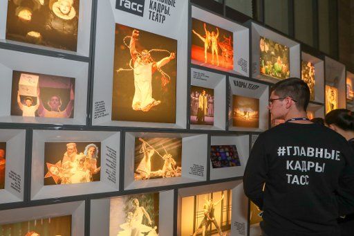 ST PETERSBURG, RUSSIA - OCTOBER 22, 2019: Visitors view an exhibition of TASS archive photographs documenting the history of Soviet\/Russian theatre from 1948 to the present day, at Mariinsky Theatre; titled "Main Shots: Theatre", the exhibition is a ...