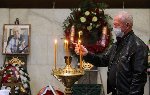 MOSCOW, RUSSIA - OCTOBER 1, 2020: A man lights a candle during a farewell ceremony for TASS Russian News Agency photographer Vladimir Musaelyan at a memorial hall of the Central Clinical Hospital of the Russian Presidential Administration. Musaelyan 