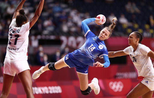 TOKYO, JAPAN - AUGUST 8, 2021: Players Polina Vedekhina (C) of ROC, Estelle Nze Minko (L) and Beatrice Edwige of France struggle in the womenâs final handball match between ROC and France at the Yoyogi National Gymnasium as part of the 2020 Summer 